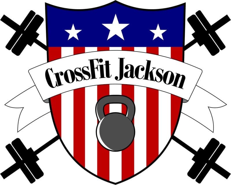 A logo featuring a shield with a red and white striped background, blue top with three stars, and a kettlebell in the center. The text reads "CrossFit Jackson."
